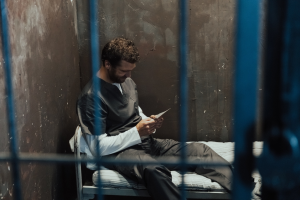 Inmate reading a letter in jail