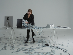 Woman with countless dollar bills scattered on the table and floor